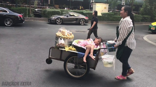 'Little Girl Sleeps On Mother\'s Street Food Cart'