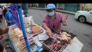 'Grilled squid on food cart thailand street food'