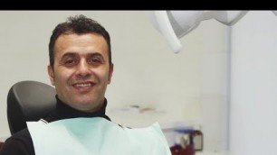 Happy Mature Man Smiling Holding an Apple Sitting in a Dental Chair | Stock Footage - Videohive