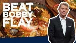 'Bobby Flay Makes Seafood Paella | Beat Bobby Flay | Food Network'