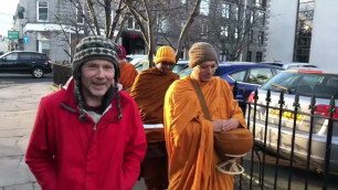 'Monks from Varapunya Meditation Center Collecting alms food in Aberdeen city Scotland'